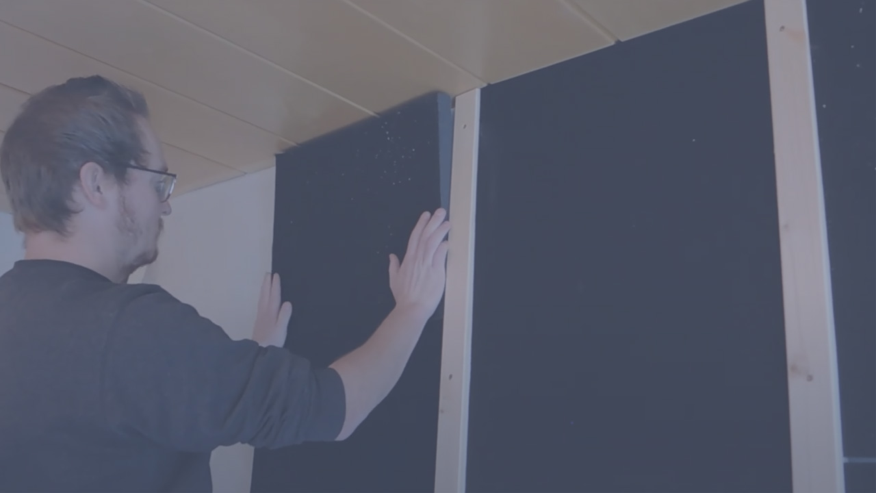 Thumbnail Man installs soniflex soundproofing elements on the wall