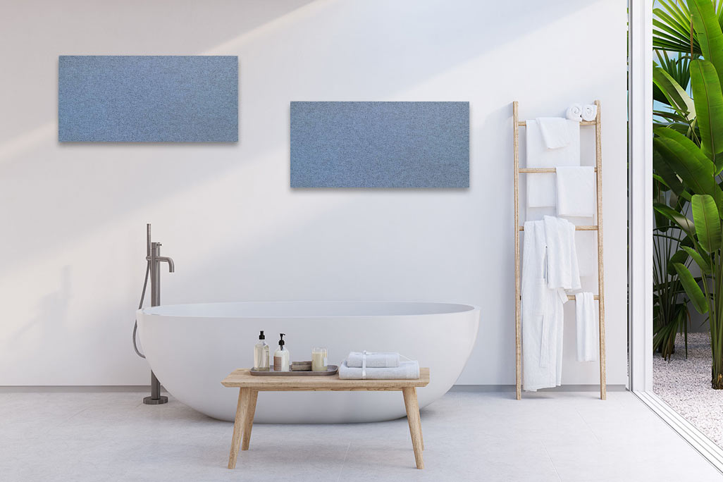 Bright bathroom with a white bathtub and a white wall with two rectangular acoustic elements in blue.