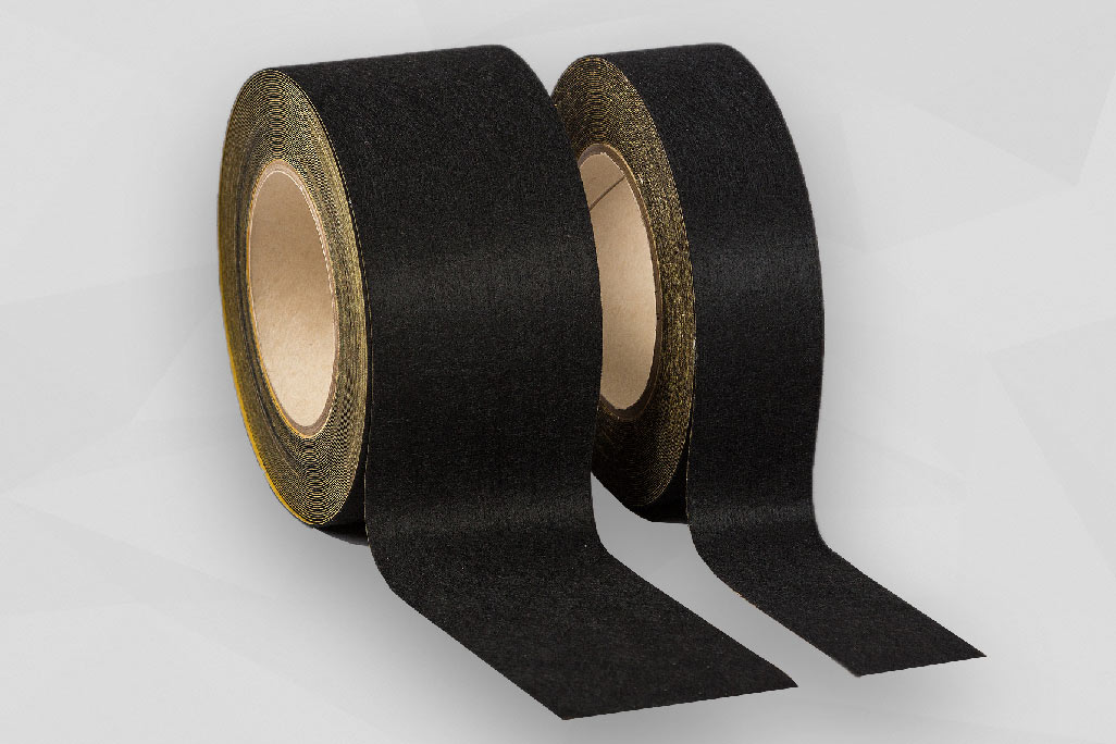 2 rolls of non-woven adhesive tape in two different widths standing next to each other