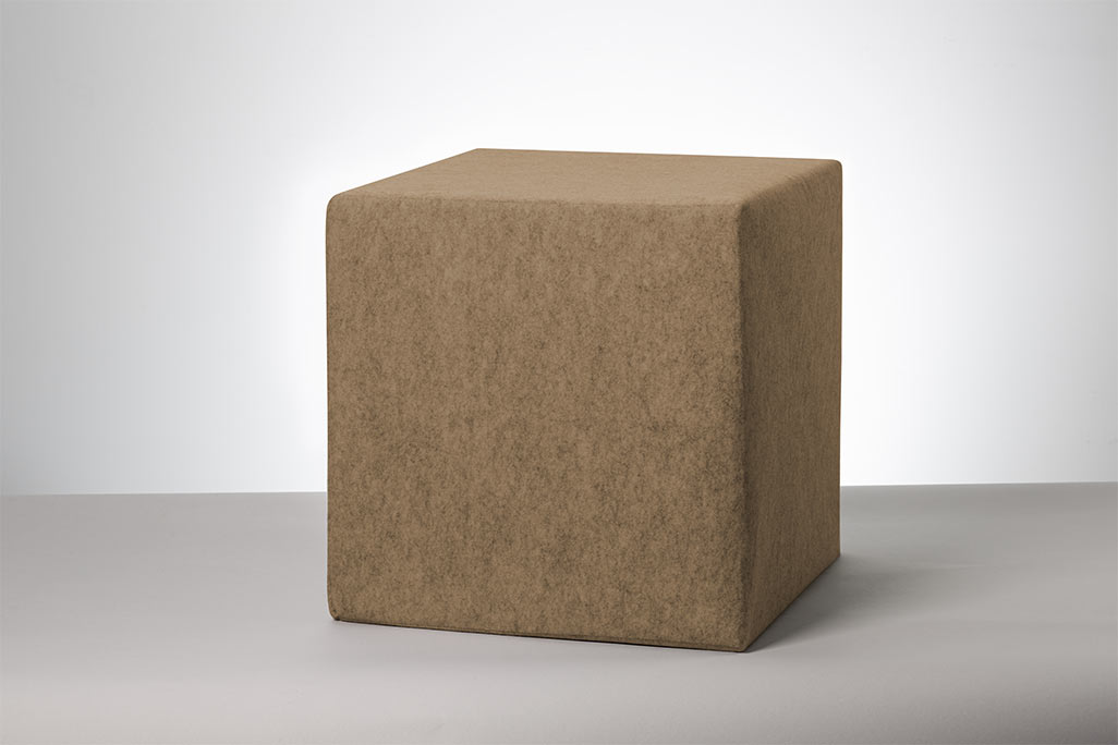 Beige seating cube photographed against a white background.
